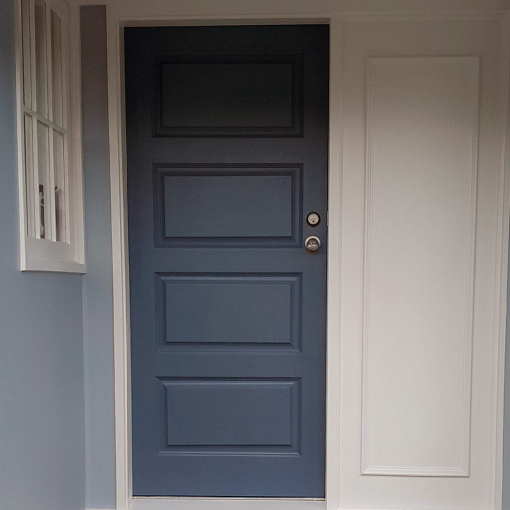 The image is of a grey door with silver door handle. It is a front door that has been painted recently.