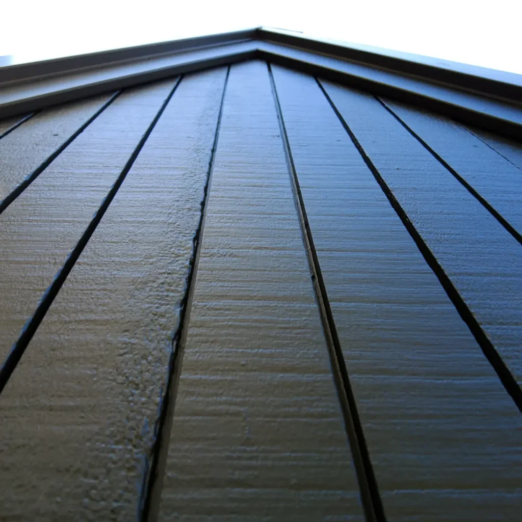 A close up of vertical cladding after being painted using Weathershield® ColourGuard™ Rawene.