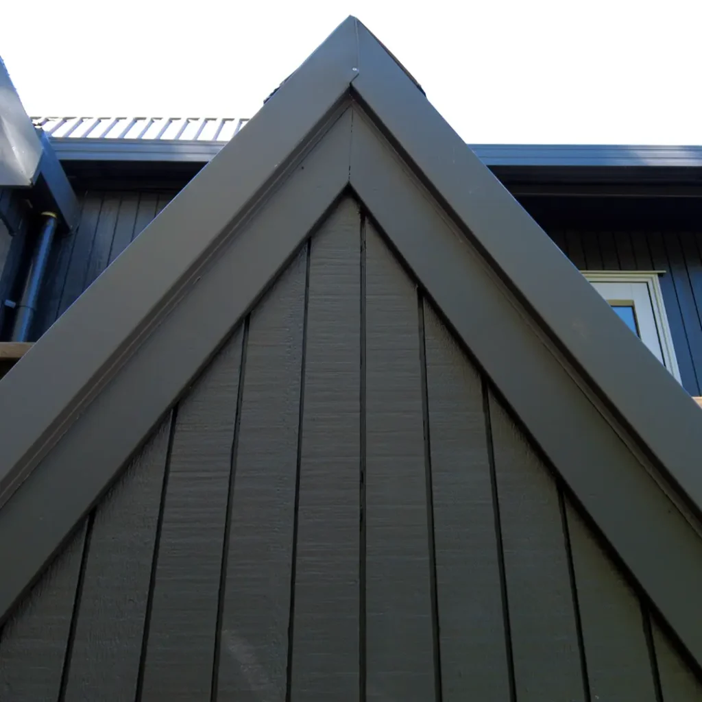 The image shows the entrance to a home. The background includes a grey sky. The property has been recently painted with Weathershield® ColourGuard™ Rawene.