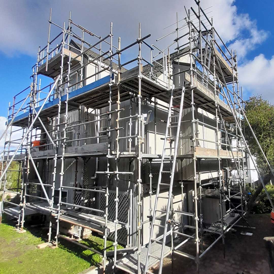 a house before painting with scaffolding