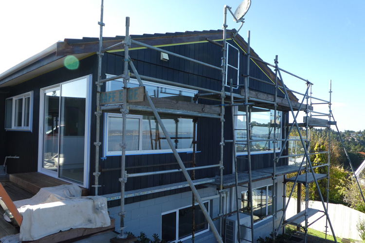 a house before exterior painting with scaffolding