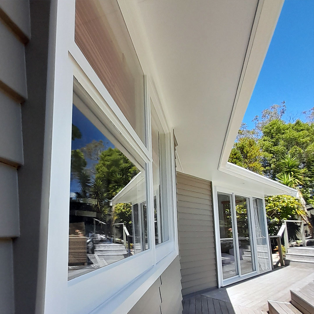 Grey weatherboard home painted with white trim