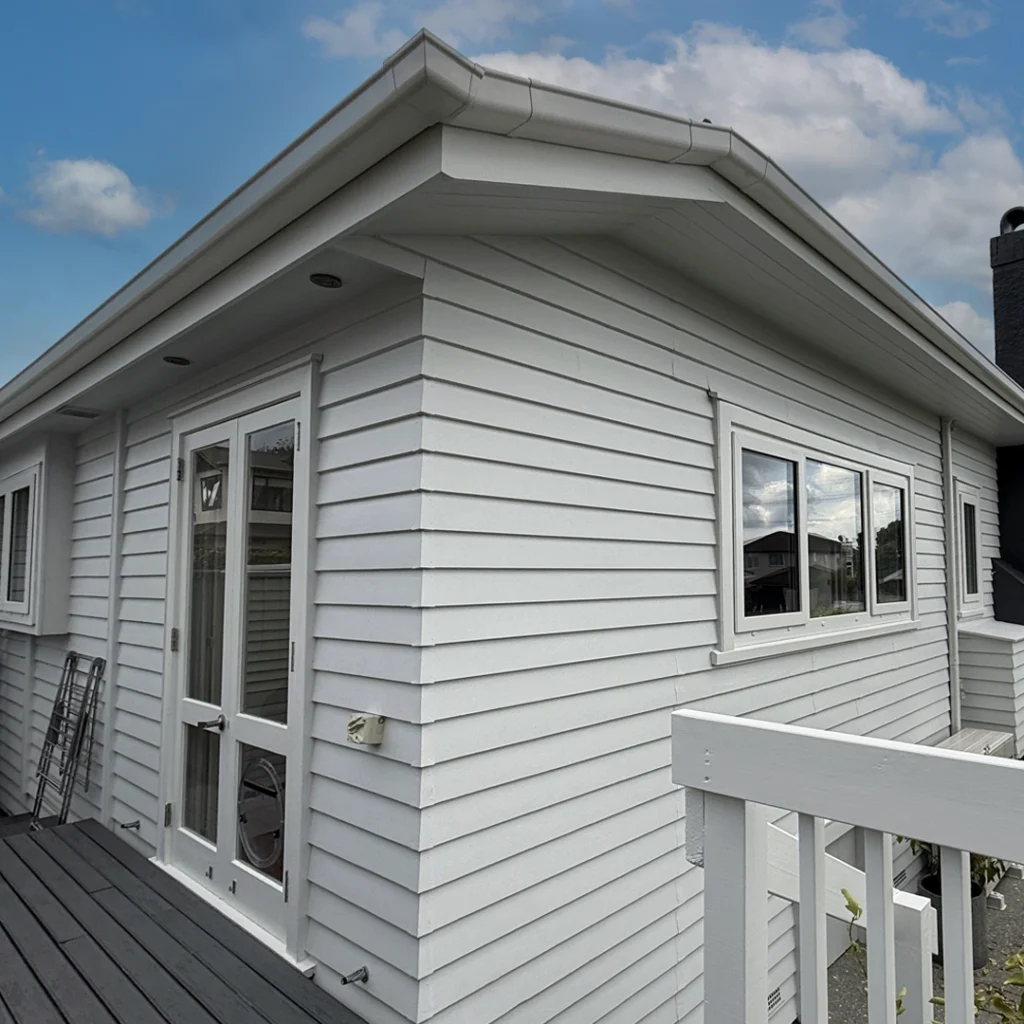 Repainted Bayswater villa with soft grey exterior and white trims by The House Painters, Auckland.