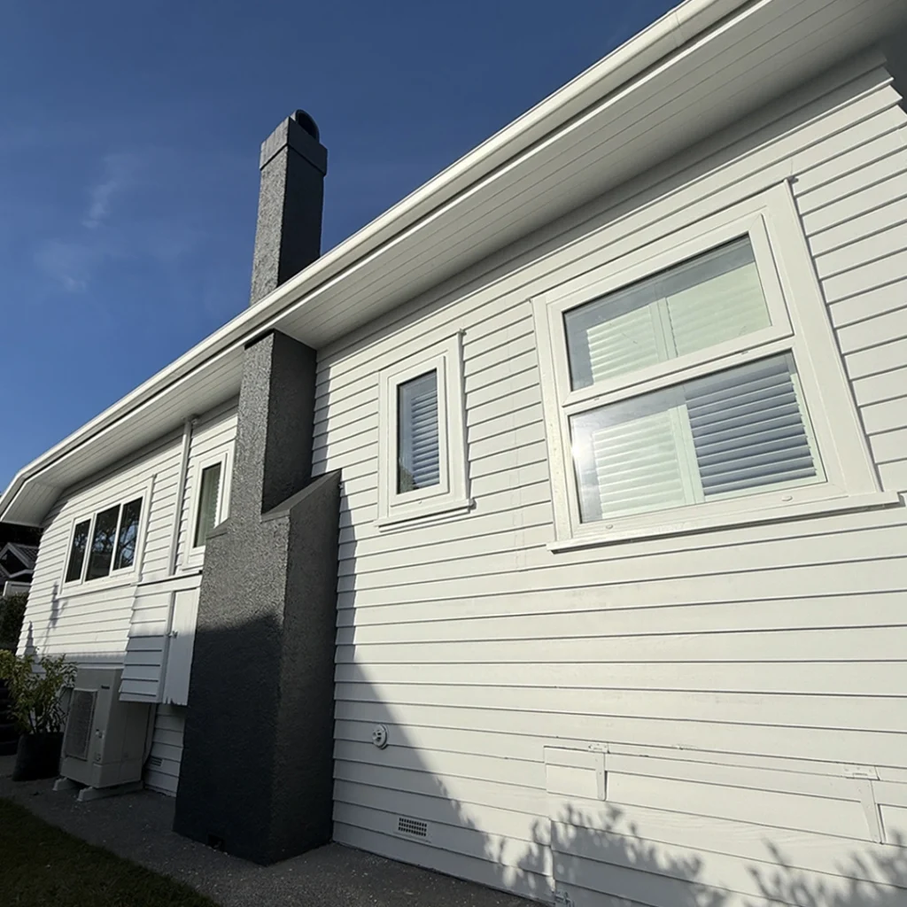 Freshly painted side view of Bayswater weatherboard villa by The House Painters, Auckland.